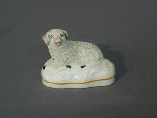 A Staffordshire figure of a seated sheep 3" (ears chipped)