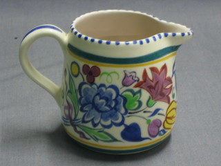 A Poole Pottery circular jug with floral decoration, base with Dolphin mark 3"