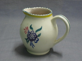 A Poole Pottery jug with floral decoration, the base with Dolphin mark 4"