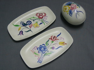 A Poole Pottery trinket box in the form of an egg 3 1/2" and 2 Poole Pottery spoon rests 7"