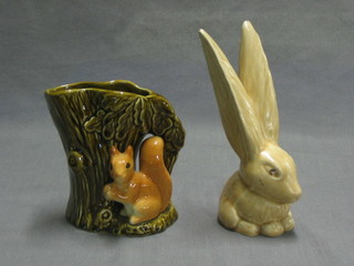 A Sylvac figure of a brown glazed seated rabbit 7" and a Sylvac vase in the form of a tree stump with squirrel 5"