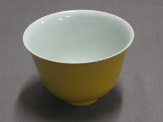An Oriental 18th Century yellow glazed rice bowl, the base with 6 character mark, (base and rim chipped) 3"