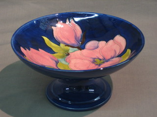 A Moorcroft Magnolia pattern blue glazed pedestal bowl, the base with Moorcroft signature 4"