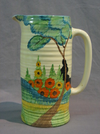 A large Clarice Cliff pottery jug decorated a garden scene with tree and flowers, the base marked Bizarre Clarice Cliff, 11"