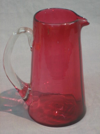 A Victorian cranberry jug with clear glass handle 7"