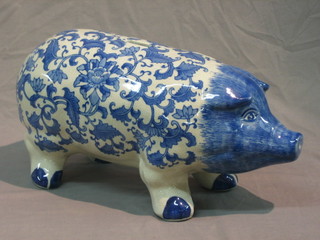 An Oriental style blue and white pottery piggy bank in the form of a pig 17"
