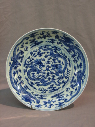 An Oriental blue and white dish with dragon decoration, the reverse with 6 character mark 12"