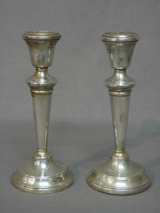 A pair of silver candlesticks, London 1956 and 1957, 8"