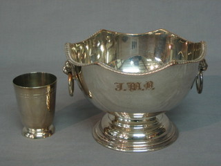 A silver plated pedestal bowl raised on a spreading foot with lion mask handle and a beaker (2)