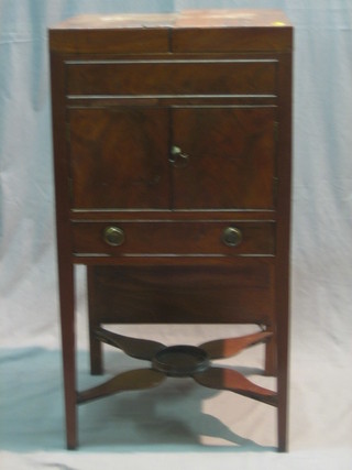 A Georgian mahogany enclosed washstand with hinged lid, the base fitted a cupboard and a drawer, raised on square tapering supports with undertier, 18"