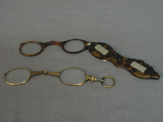 A pair of tortoiseshell lorgnettes and a pair of gilt metal lorgnettes