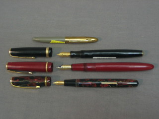 A black Parker Duofold fountain pen and a red ditto, a Burnham No.50 fountain pen and 1 other fountain pen