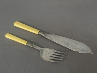 A pair of silver plated fish servers with engraved blades