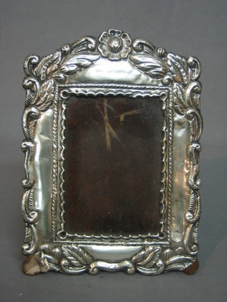 A Peruvian embossed silver easel photograph frame (some tears) 9" x 6"