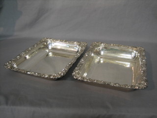 A pair of rectangular silver plated entree dish bases with cast borders