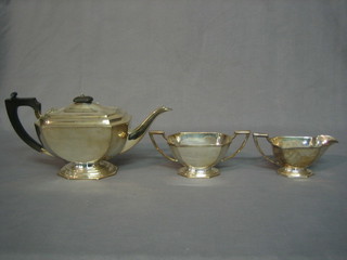 An Art Deco rectangular 3 piece silver plated tea service with teapot, twin handled sugar bowl and milk jug