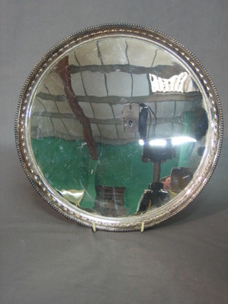 A circular silver plated salver with pierced liner, raised on 3 bun feet, 12"