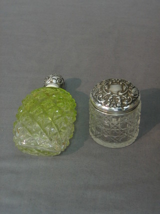 A cut glass perfume bottle with embossed silver lid 4" and a cylindrical rouge pot with silver lid 2"