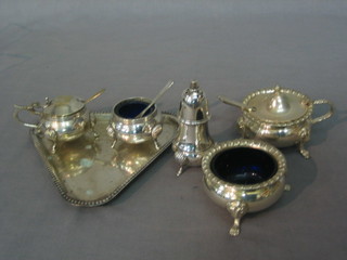 A 3 piece silver plated cruet comprising mustard pot, salt, pepper and stand together with a large mustard pot and salt