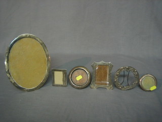 A circular white metal easel photograph frame 9" and 5 other easel photograph frames