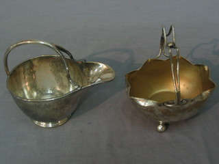 A silver plated cream jug and a silver plated sugar bowl, raised on 3 bun feet