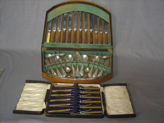 A set of 6 silver plated fish knives and forks and an oak canteen box containing a collection of flatware