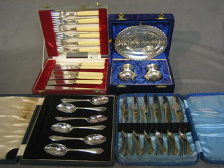A set of 6 silver plated grapefruit spoons, 6 silver plated fish knives and forks x 2, and a silver plated 2 piece condiment and stand, all cased