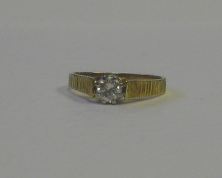 A modern gold dress ring set a diamond