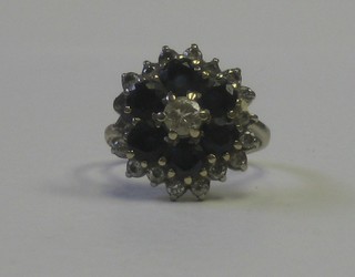 An 18ct white gold cluster ring set sapphires and diamonds