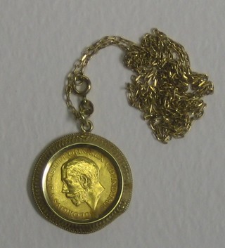 A George V 1918 sovereign contained in a gold mount hung on a fine gold chain