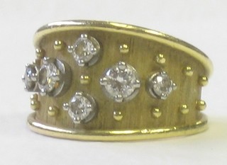 A modern design 18ct gold dress ring set diamonds