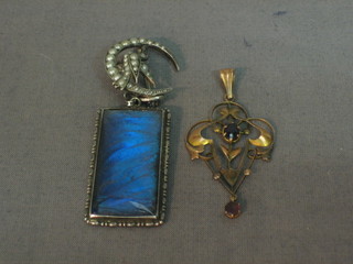 A gold pendant, a silver pendant and a brooch