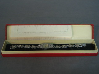 A lady's cocktail wristwatch contained in a marcasite case, with original bill of sale