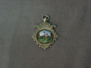 A silver and enamelled watch chain medallion decorated a cricketer at the crease