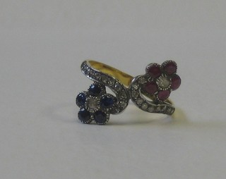 A lady's 18ct yellow gold dress ring in the form of 2 entwined flowers, set rubies, sapphires and diamonds