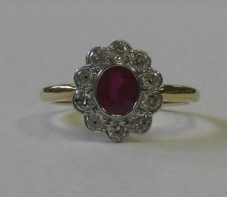 A lady's 18ct gold dress ring set an oval ruby surrounded by 10 diamonds