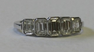 A lady's 18ct white gold dress ring set 5 baguette cut diamonds approx 1ct