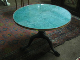 A 19th Century circular tea table with malachite finished top and brass banding, raised on a turned column and tripod base 27"