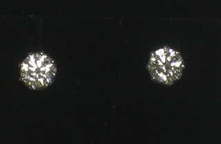 A pair of gold and diamond claw set ear studs, approx 1.03ct