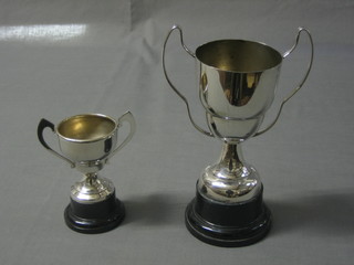 A silver plated twin handled trophy cup 5" and 1 other 4"