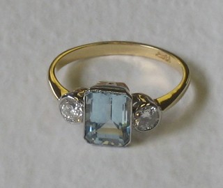 An 18ct yellow gold dress ring set a rectangular cut aquamarine supported by 2 diamonds