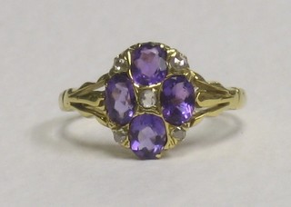 An 18ct yellow gold dress ring set 4 oval cut amethysts surrounded by 5 diamonds