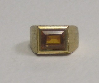 An 18ct gold ring set a rectangular amber coloured stone