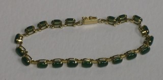 A 14ct gold bracelet set oval cabouchon green stones