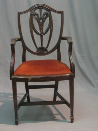 A pair of Georgian style mahogany open arm carver chairs with shield back and upholstered drop in seats raised on square tapering supports
