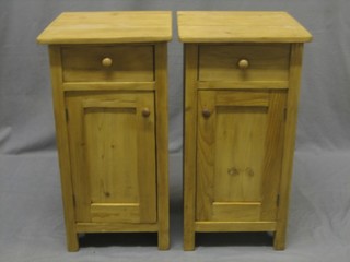 A pair of pine bedside cabinets fitted a drawer above a cupboard 14"