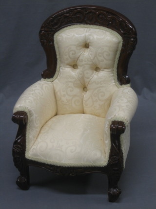 A reproduction Victorian style carved mahogany childs arm chair with button back