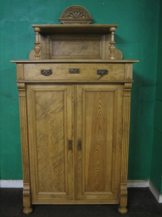 A 19th Century Continental pine cabinet with raised back fitted 1 long drawer above a double cupboard raised on turned supports 40"