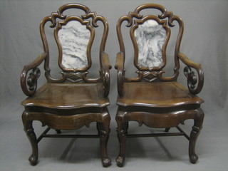 A handsome pair of 19th Century mahogany open arm chairs with white veined marble panelled backs