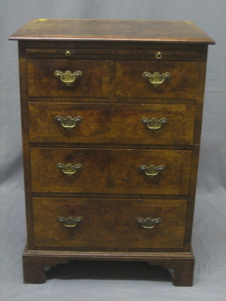 A Queen Anne style figured walnut chest of 2 short and 3 long drawers, fitted a brushing slide raised on bracket feet 22"